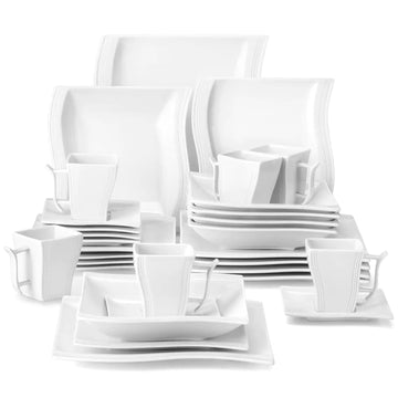 Set of white ceramic dinnerware including plates, bowls, and cups on a white background#color_ivory-white