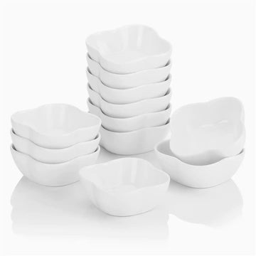 Set of 12 ivory white porcelain mini ramekins filled with various dipping sauces, perfect for appetizers and entertaining.