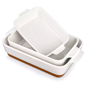 Set of three ceramic baking dishes with brown bottoms on a white background