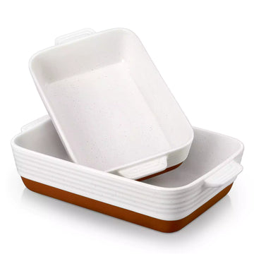 Set of ceramic baking dishes with brown bottoms on a white background