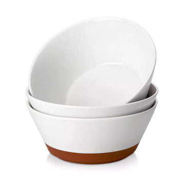 Set of three white bowls with brown bottoms on a white background