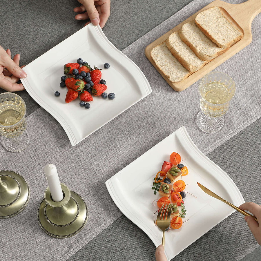 MALACASA Flora porcelain plates featured in a refined dining scene with fruit, bread, and crystal glasses